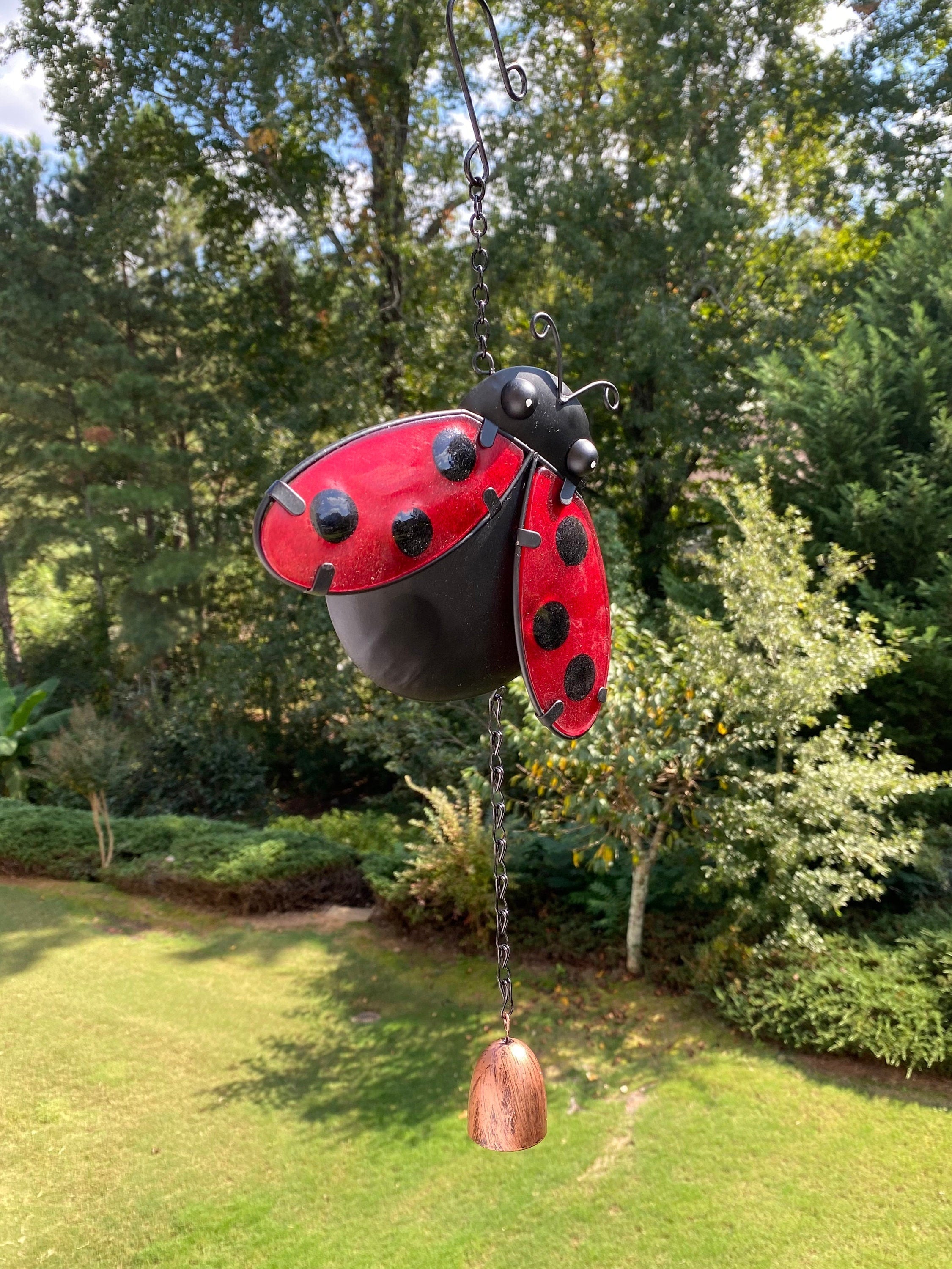 Red and black ladybug-shaped garden ornament wind chime for outdoor decor