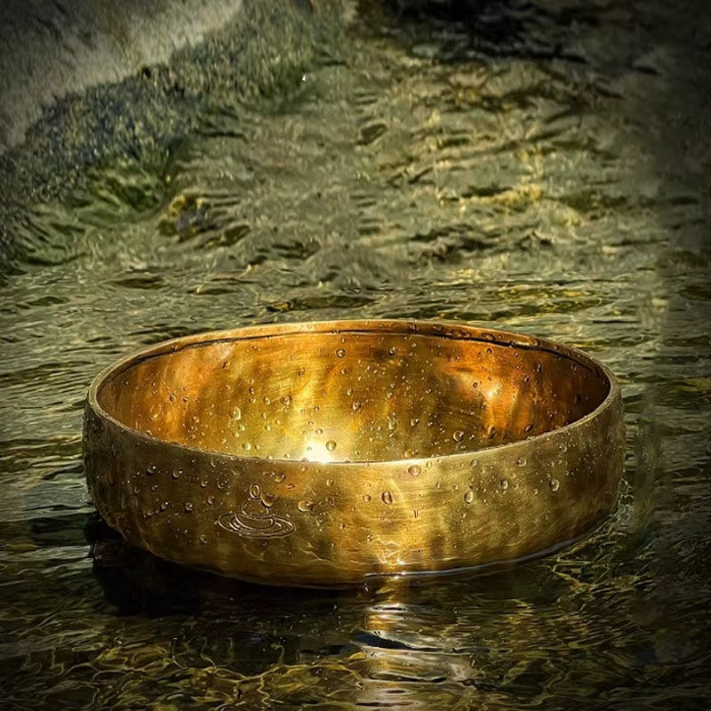 Golden brass singing bowl with textured surface for meditation and relaxation