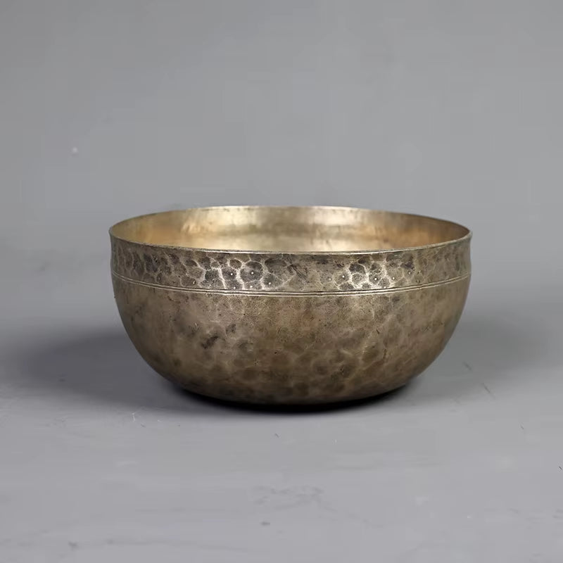 Hammered metal singing bowl with decorative rim for meditation and yoga use