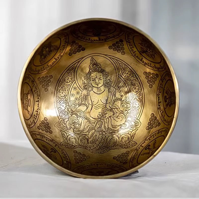 Golden Tibetan Singing Bowl for Sound Healing with intricate Buddhist deity engravings