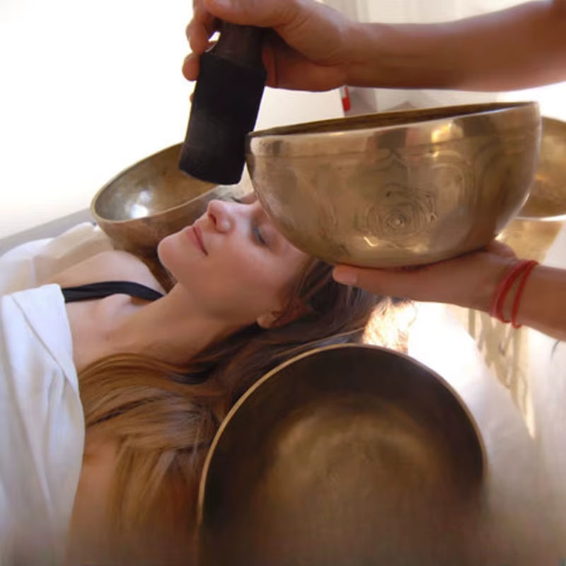 Tibetan singing bowl used in sound therapy session for healing and relaxation