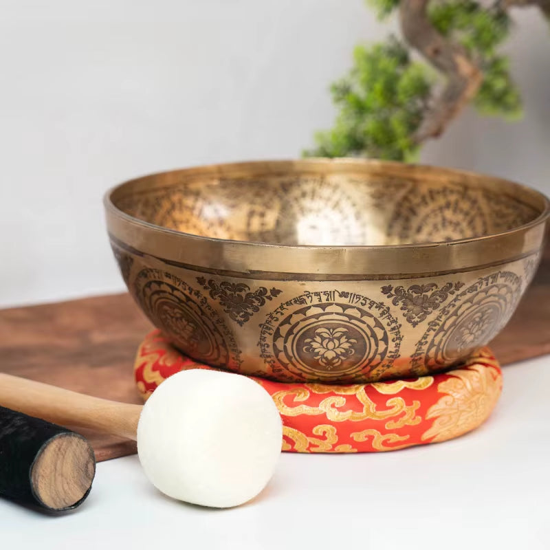 Ornate Large Tibetan Singing Bowl on red cushion featuring etched mandala patterns