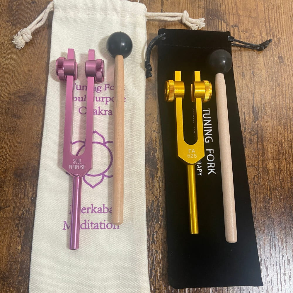 Two tuning forks in pink and gold with pouches from Merkaba Soul Purpose set