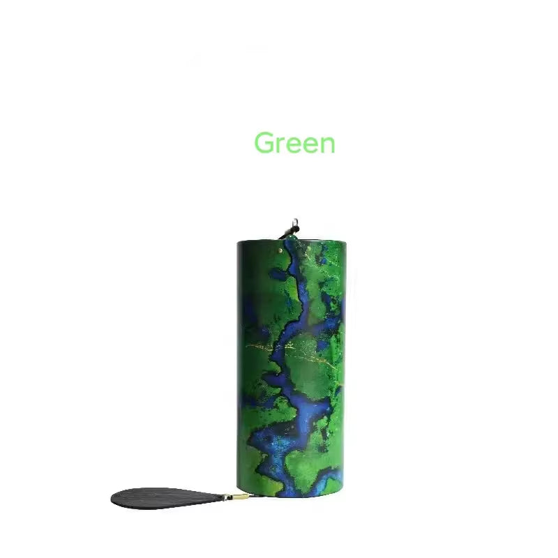 Cylindrical candle featuring blue and green marbled patterns for Metal Koshi Wind Chimes