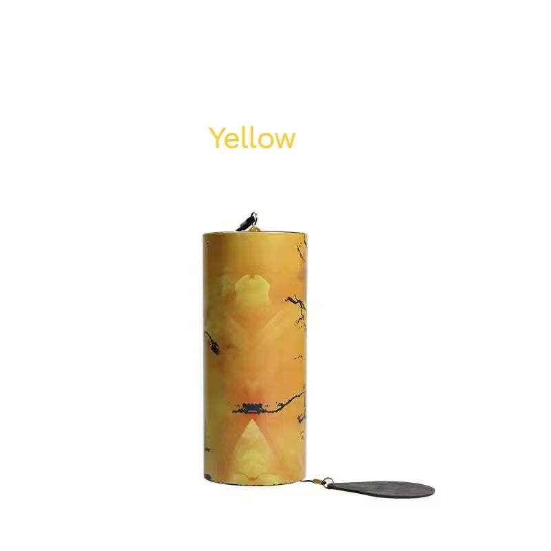 Yellow cylindrical candle with bird and branch designs for Metal Koshi Wind Chimes