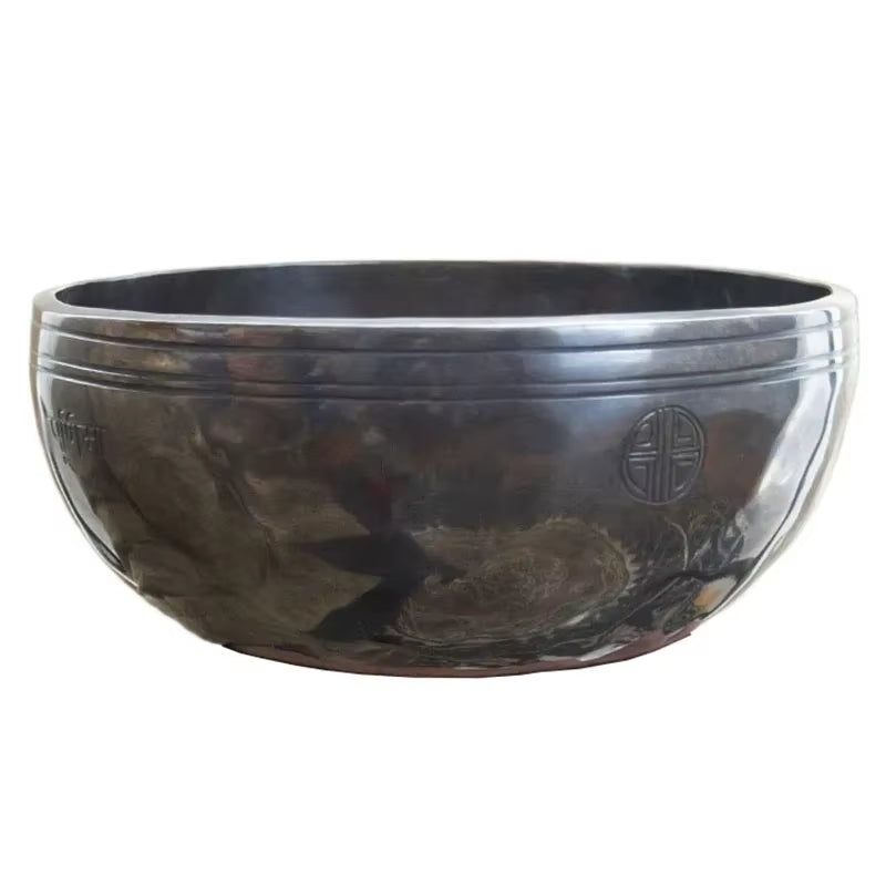 Dark metallic singing bowl with intricate designs from Nepal Handmade Buddhist Sound Bowls