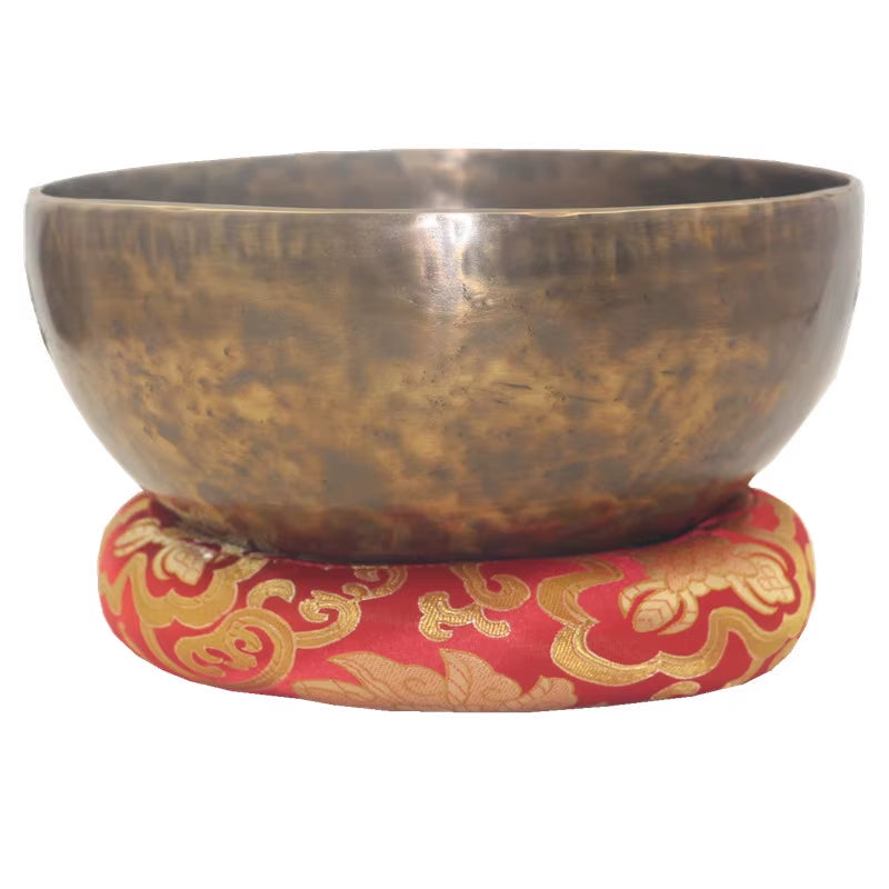 Tibetan singing bowl on a red and gold cushion from Nepal Handmade collection