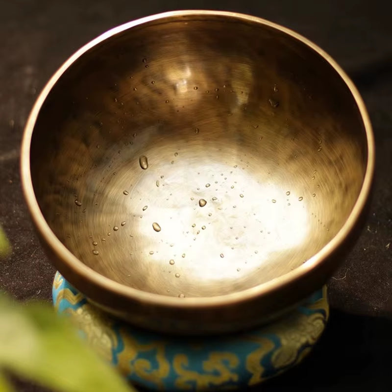 Nepalese Handmade Brass Buddhist Singing Bowl on a decorative cushion