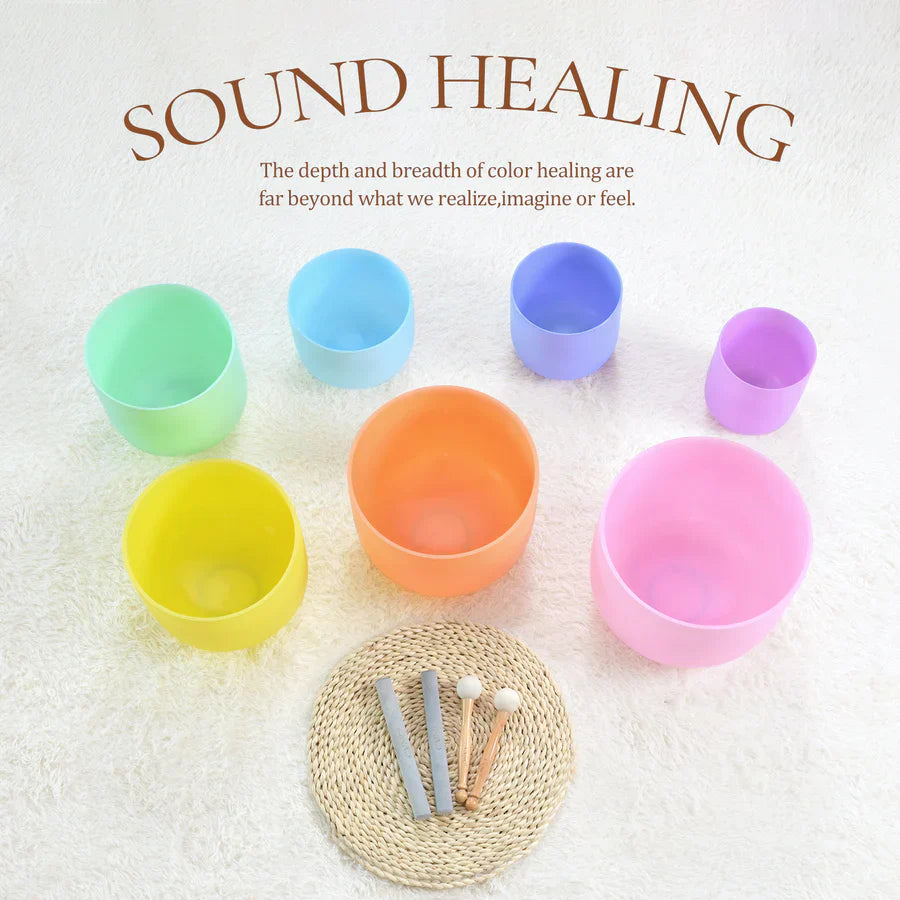 Colorful Pastel Crystal Singing Bowls arranged in a circle on a woven mat for meditation