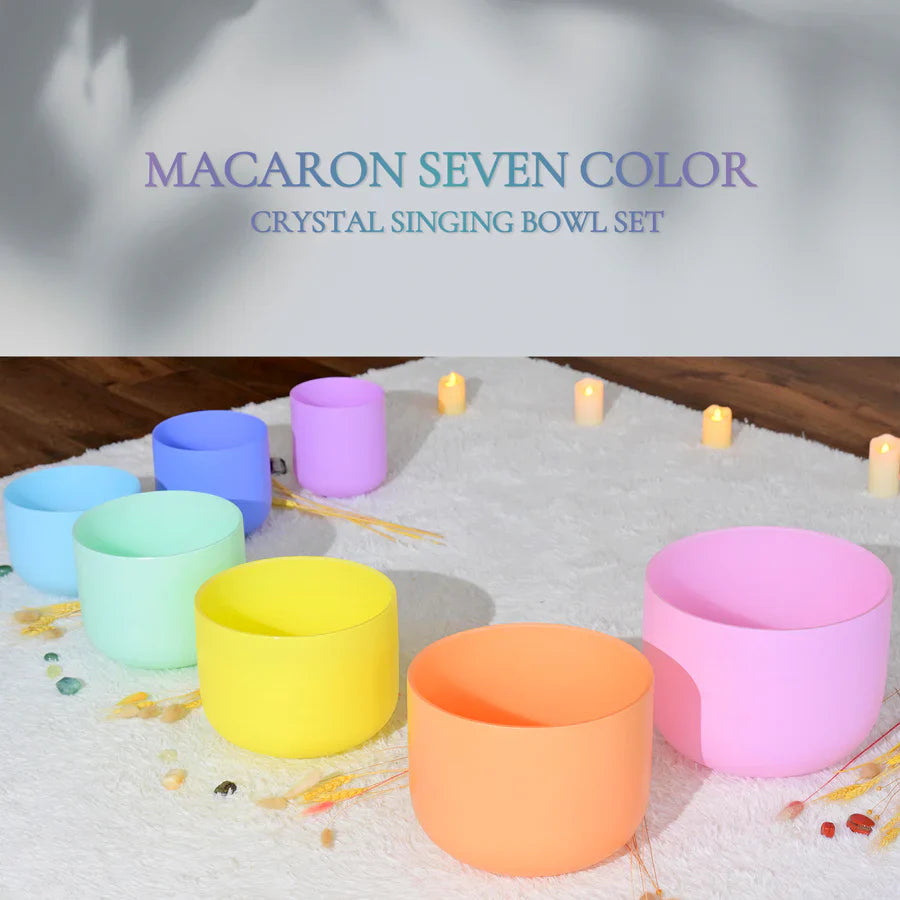 Seven pastel-colored crystal singing bowls in a curved line for meditation