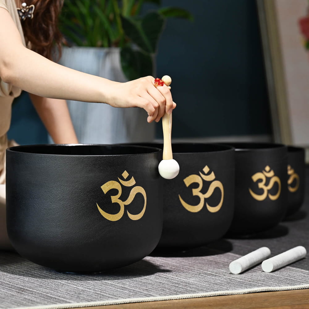 Black crystal singing bowls with golden Om symbols in Perfect Pitch set