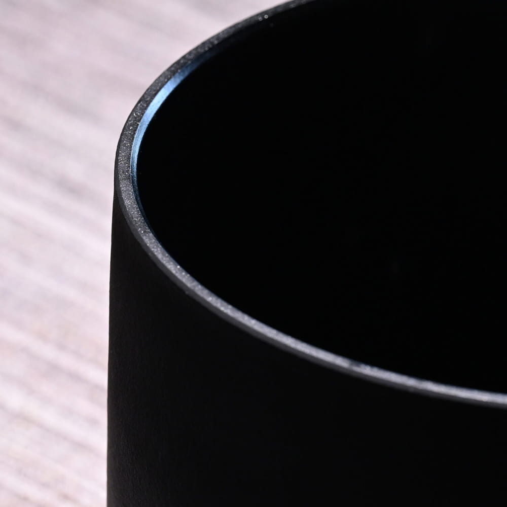 Black matte cup with curved rim from Perfect Pitch Black OM Symbol Crystal Singing Bowl Set