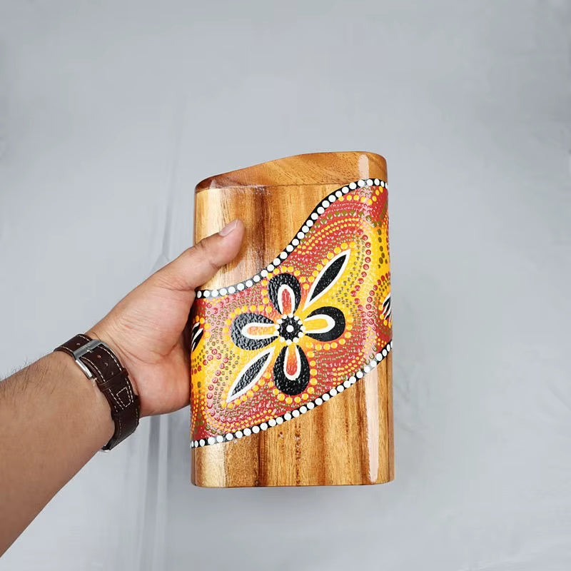 Hand-painted wooden vase with floral design in orange, yellow, and black colors