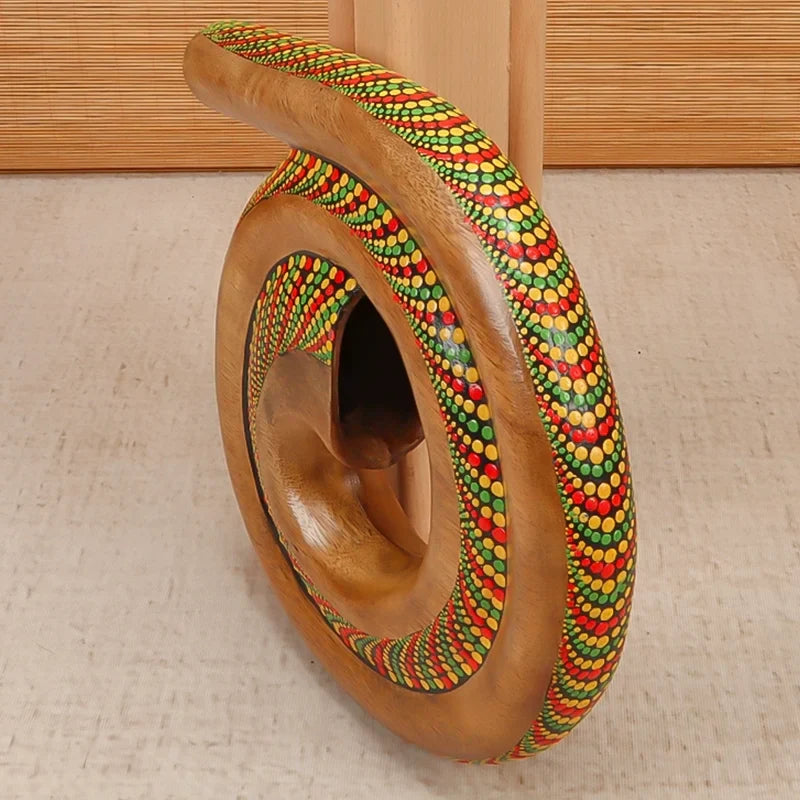 Curved wooden sculpture with colorful beaded patterns on Portable Spiral Didgeridoo