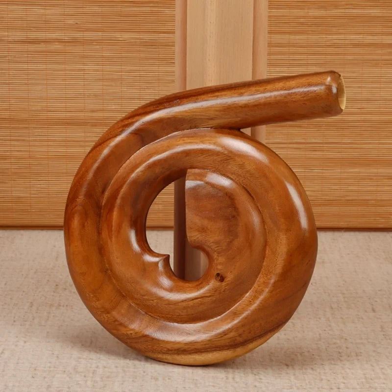 Spiral-shaped wooden sculpture with a polished finish on Portable Spiral Didgeridoo