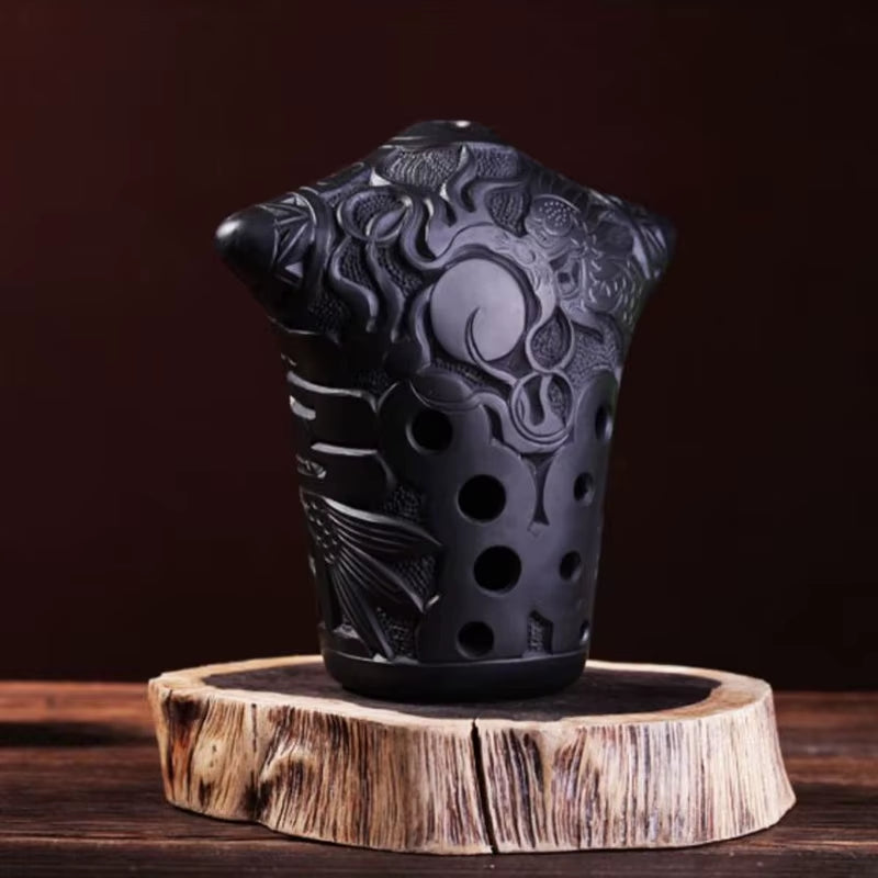 Black ceramic teacup with dragon pattern, featured in Professional 10-Hole Xun Flute