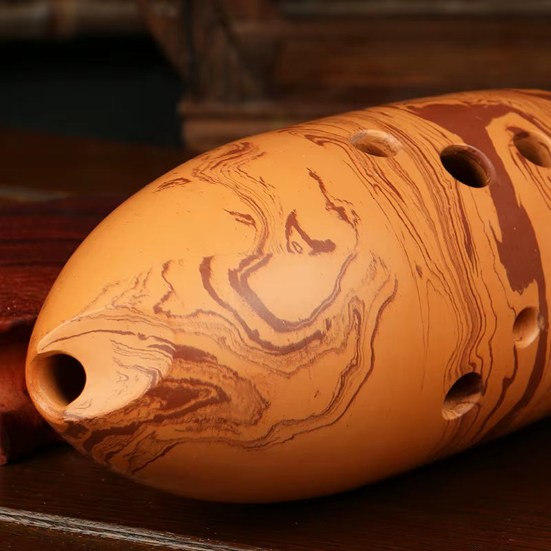 Clay ocarina with marbled patterns and finger holes featured in Professional 10-Hole Xun Flute