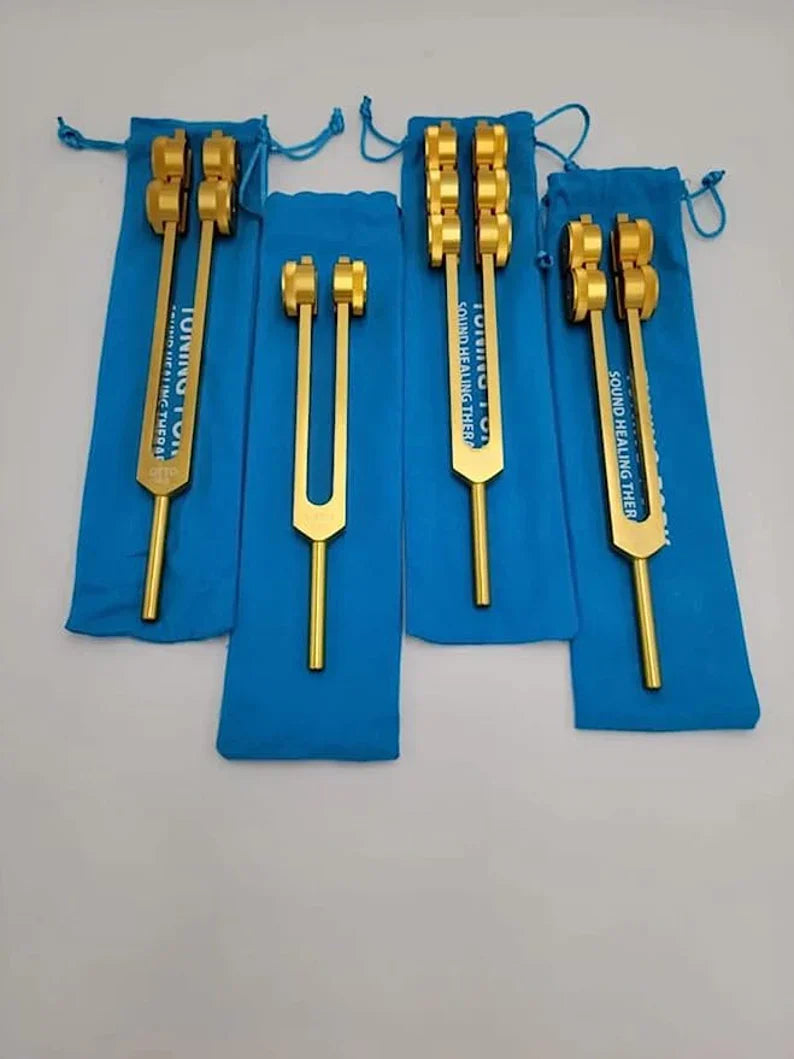 Golden tuning forks with blue protective sleeves in Professional Otto Tuners set