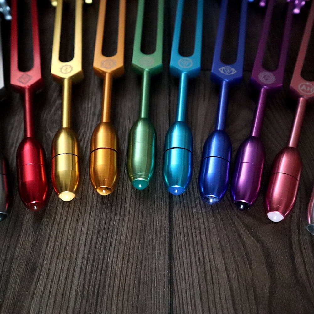 Rainbow-colored tuning forks in a spectrum for the Solfeggio 10pc Crystal Massage Set