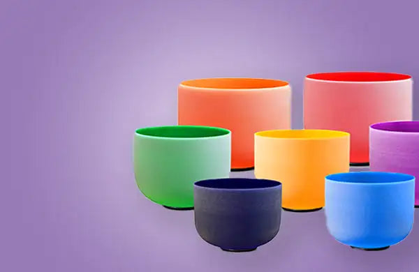 A set of colorful, smooth-surfaced crystal singing bowls arranged in a semi-circle.
