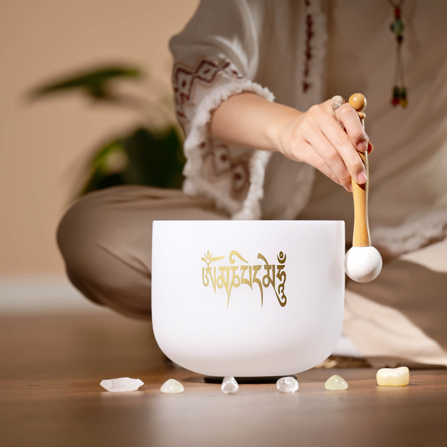 White crystal singing bowl with gold Sanskrit writing for Six-Syllable Mantra