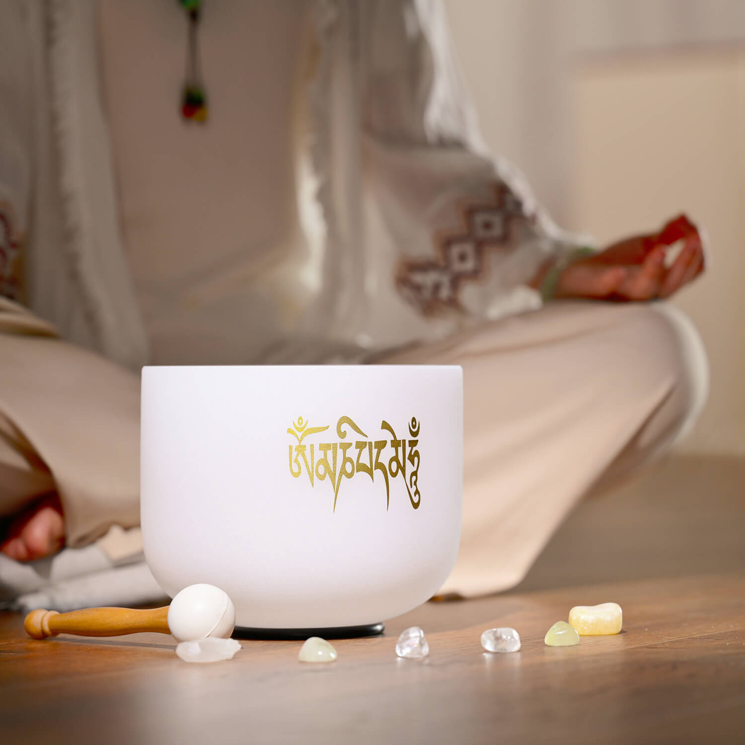 White crystal singing bowl with gold Sanskrit on Six-Syllable Mantra design