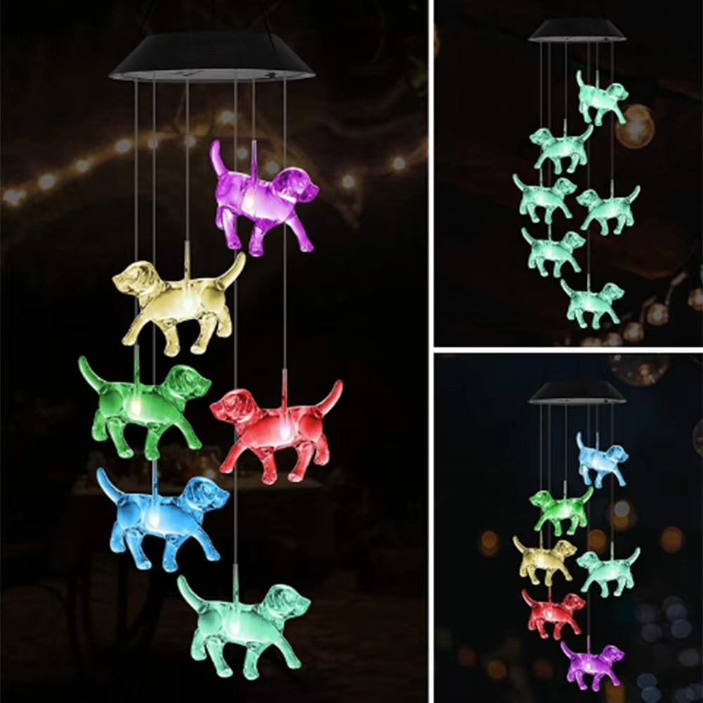 Color-changing LED dog-shaped wind chimes hanging in dark canopy outdoor decor