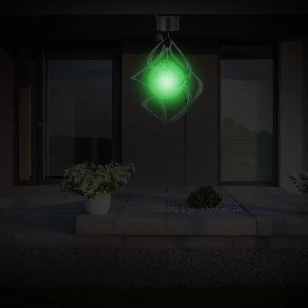 Glowing green orb in geometric metal frame of Solar LED Color-Changing Wind Chimes Outdoor