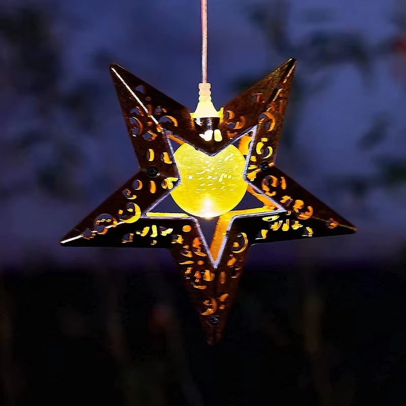 Illuminated star lantern with ornate metalwork in Solar Memorial Wind Chimes decor