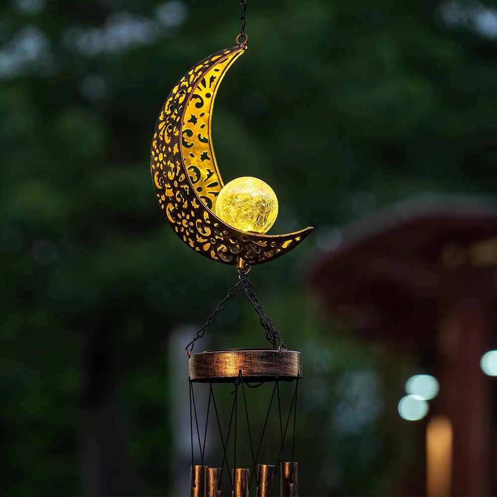 Decorative crescent moon wind chime with solar-powered light for outdoor decor