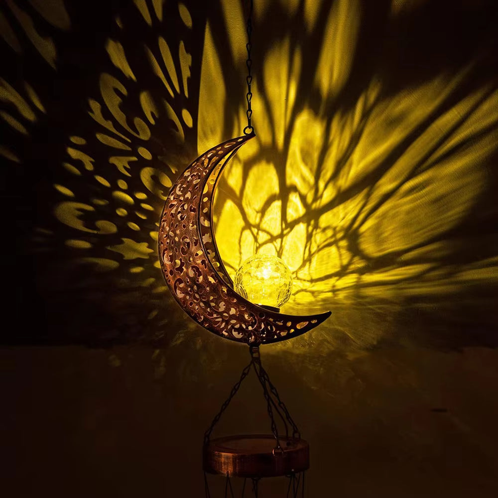 Illuminated crescent moon lantern casting shadows for Solar Moon Wind Chimes outdoor lights