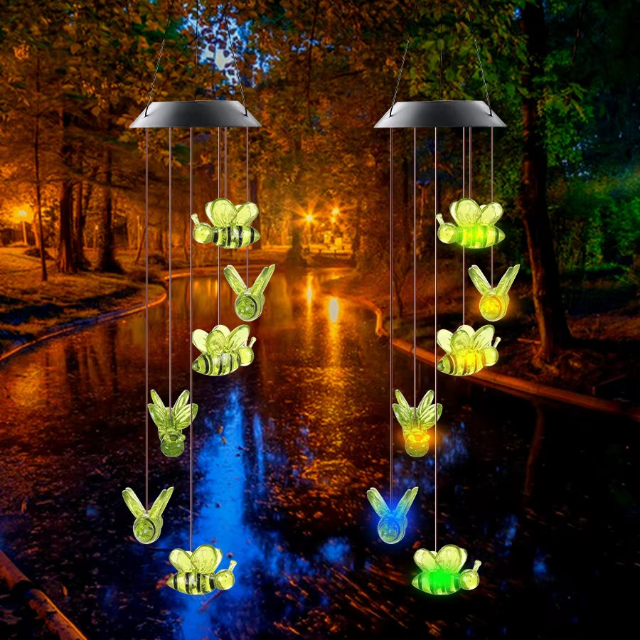 Solar-powered wind chimes with glowing butterflies and bees hanging from dome tops