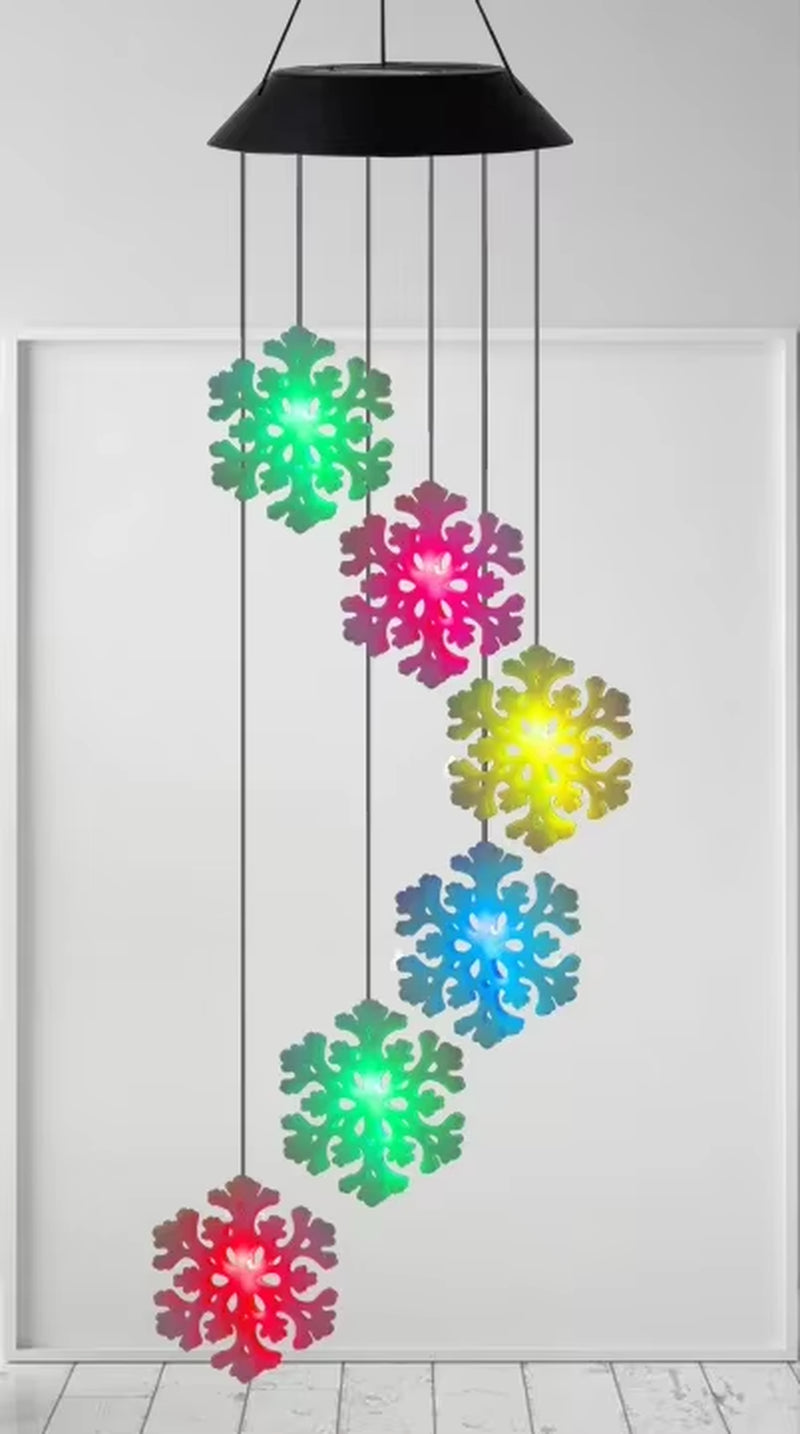 Colorful LED snowflake wind chimes hanging from a black pendant light fixture