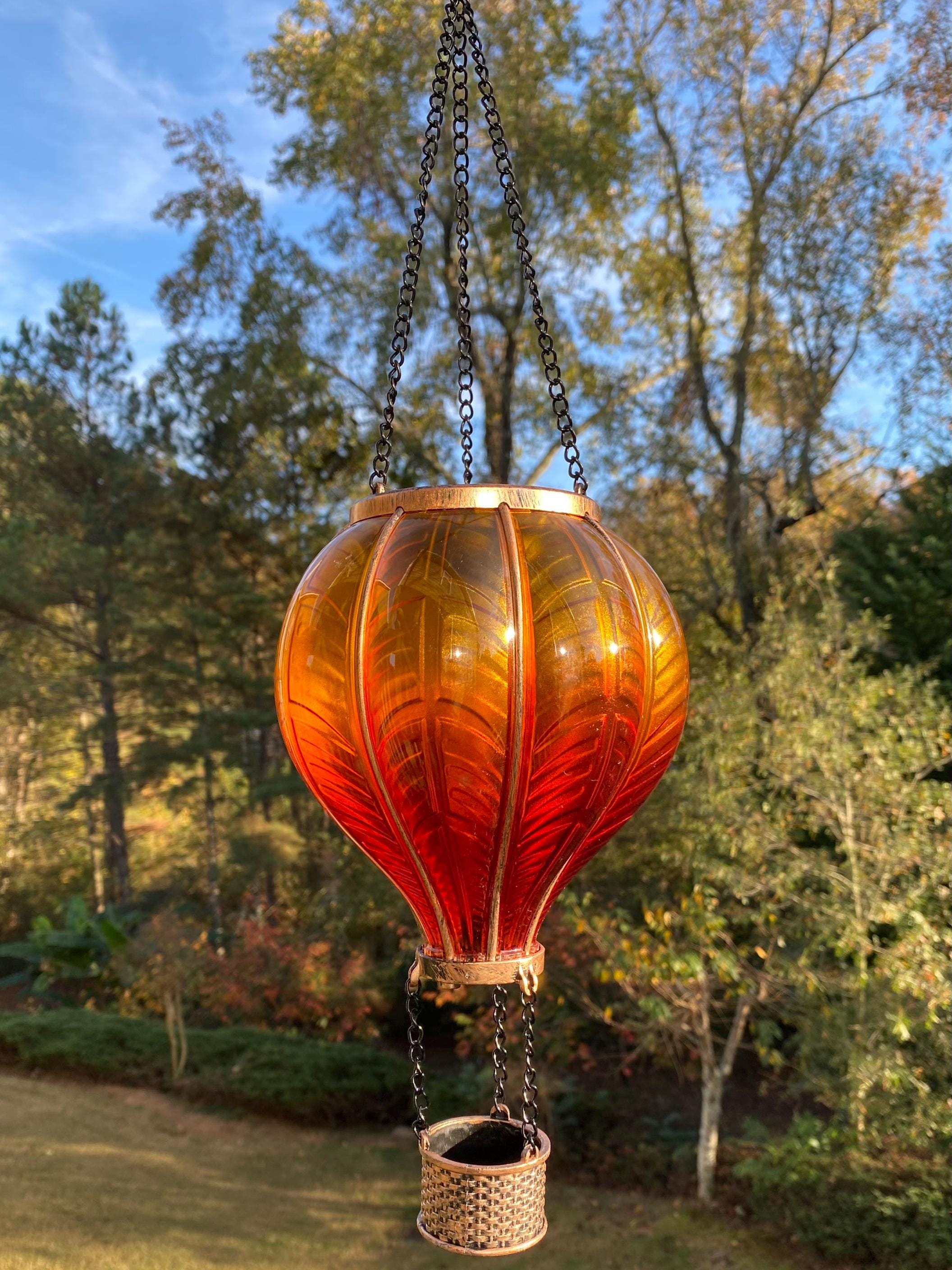 Decorative glass hot air balloon lantern in orange and amber for garden decor