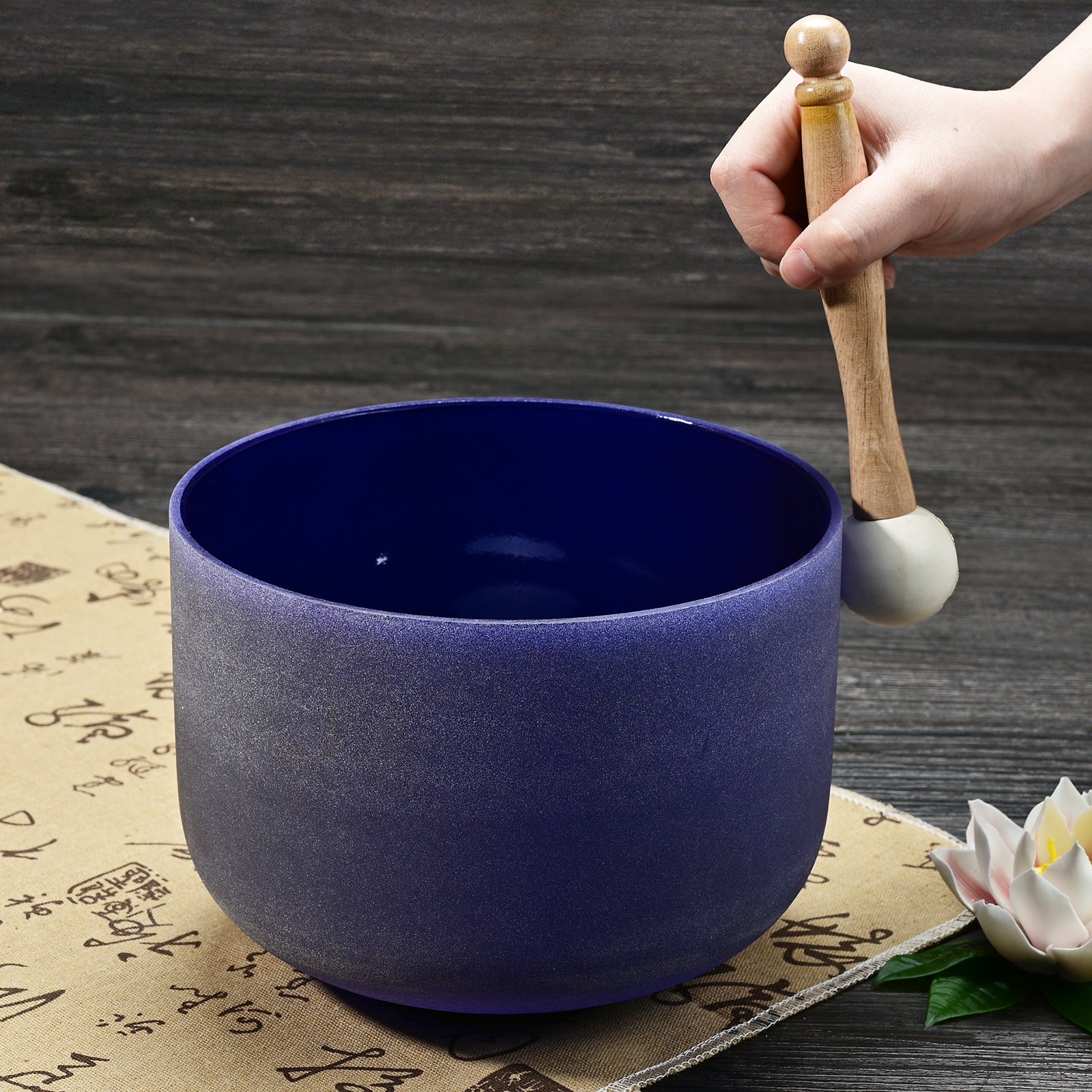 Deep blue ceramic Third-Eye Chakra singing bowl with wooden striker for healing