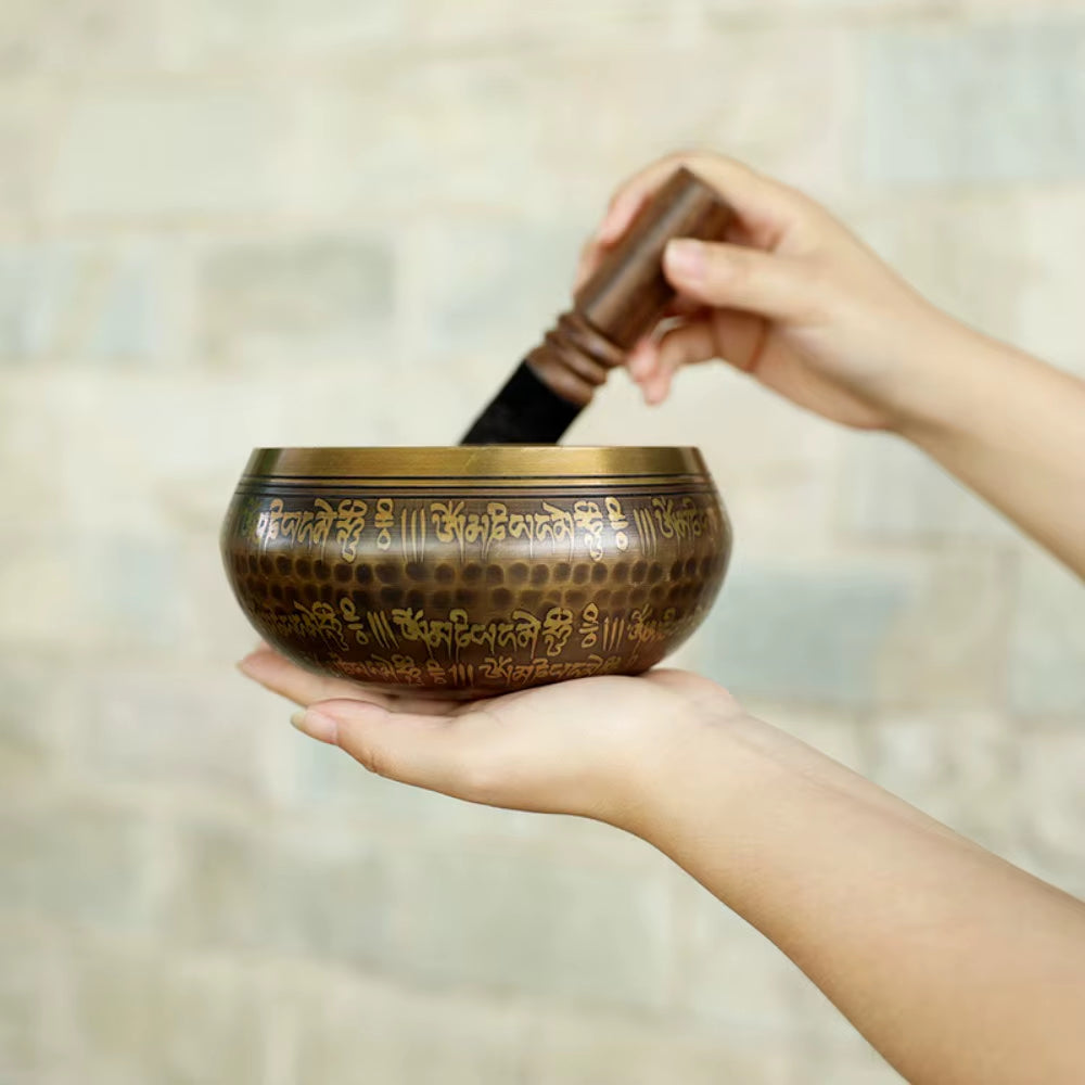 Decorative Tibetan singing bowl with etched Sanskrit mantras for sound healing