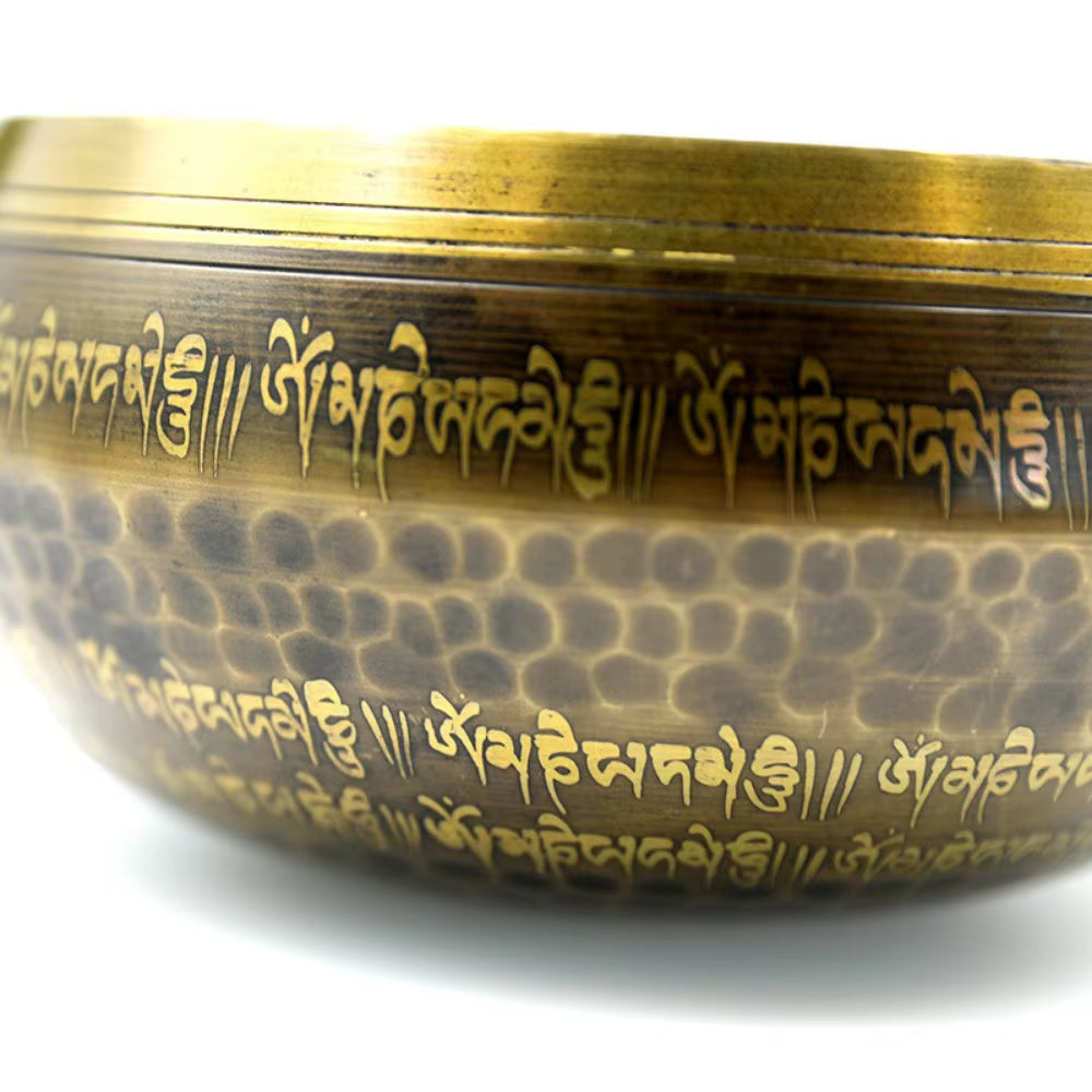 Hammered metal Tibetan singing bowl with Sanskrit inscriptions for sound healing