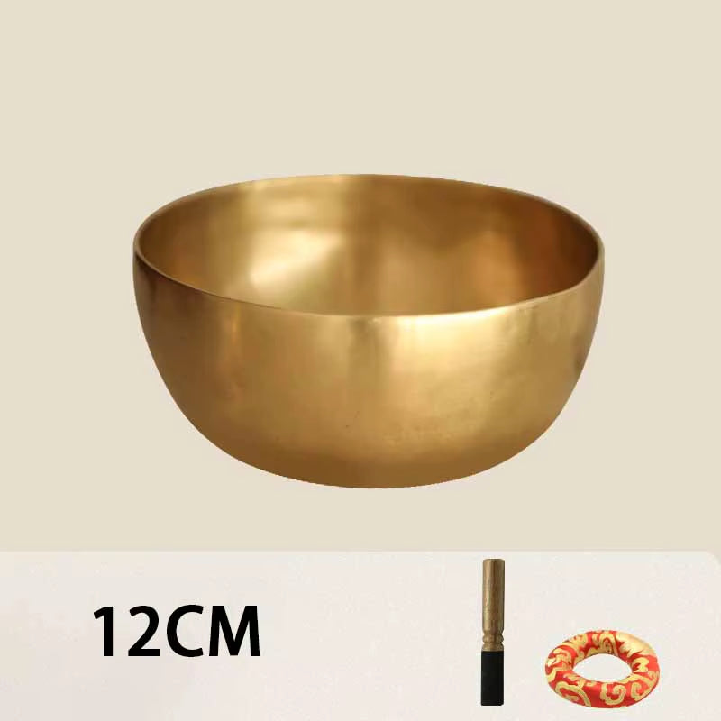 Golden metal Tibetan Buddhist singing bowl for meditation and sound healing