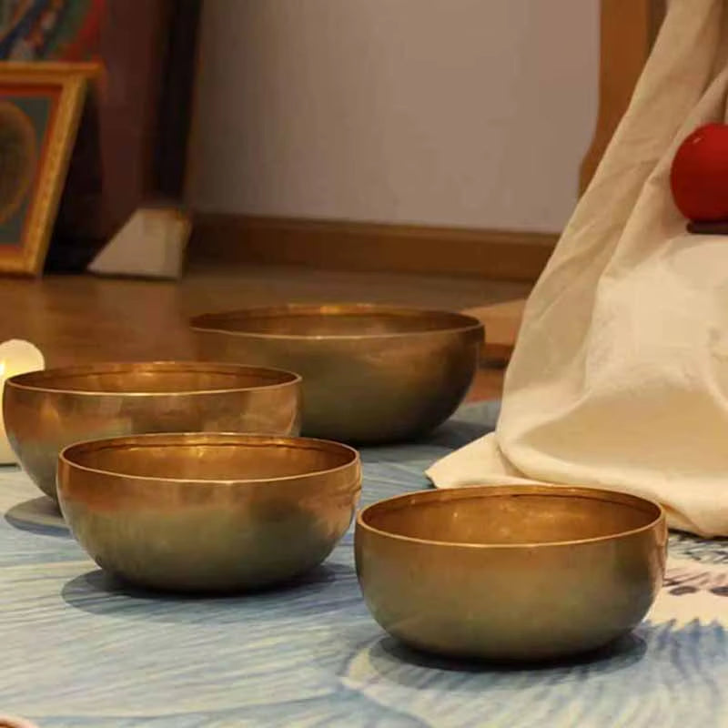 Four metallic Tibetan singing bowls for meditation and sound healing therapy