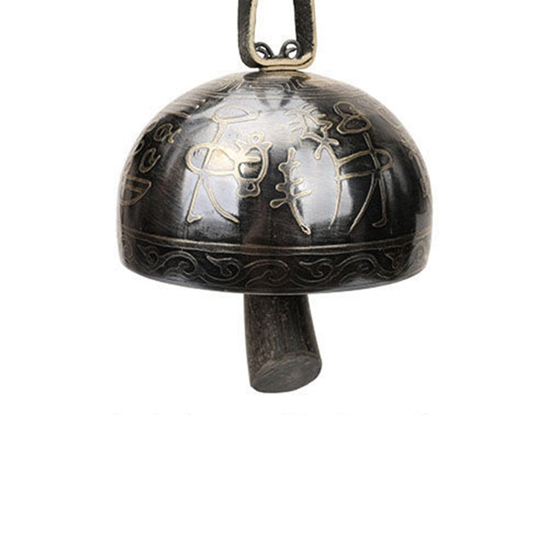 Dark metal Tibetan meditation bell with intricate decorative etched patterns