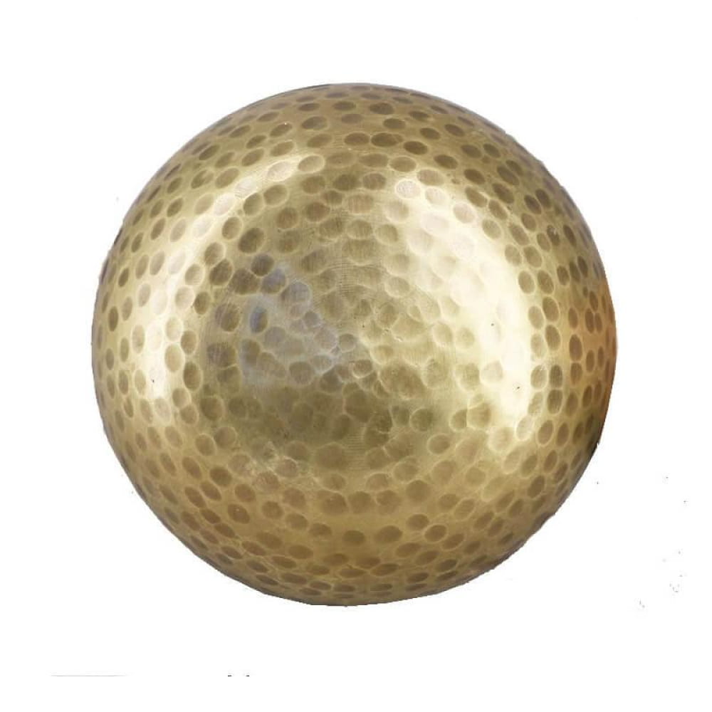 Golden golf ball with dimpled surface in Tibetan Singing Bowl for healing