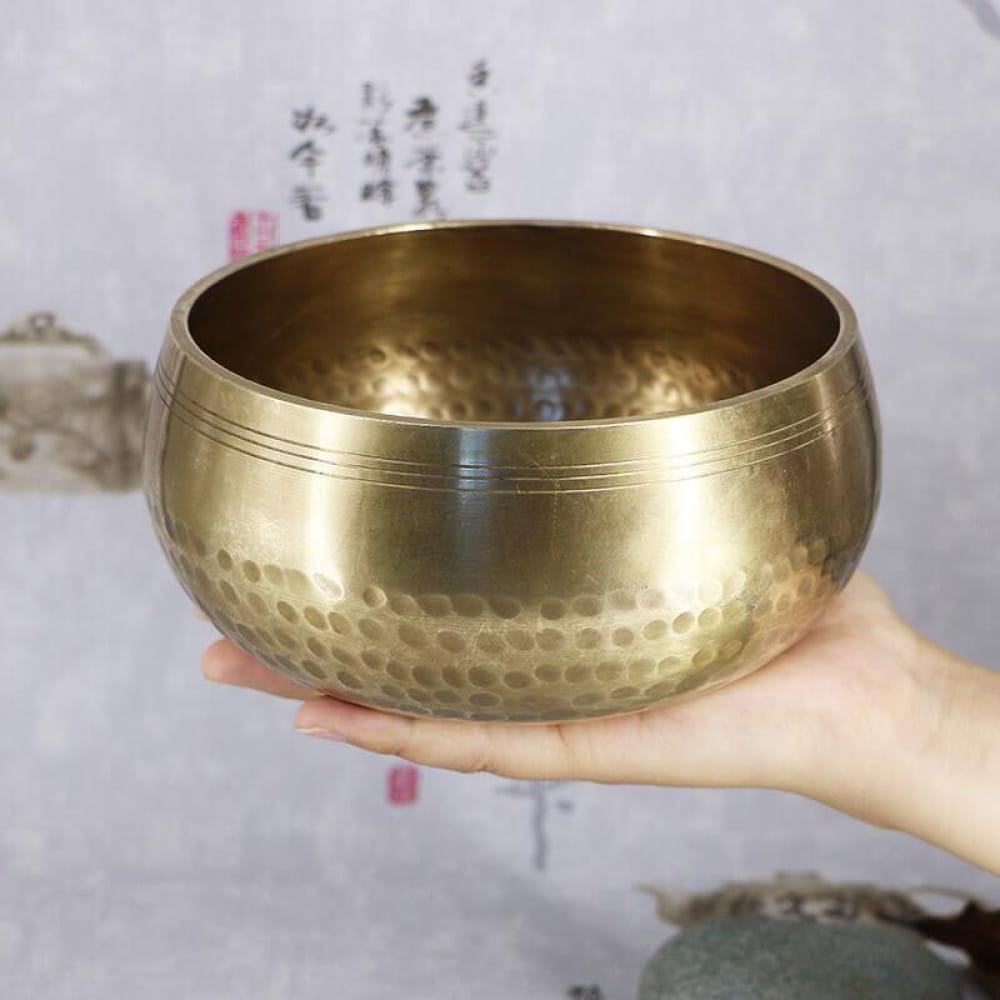 Hammered brass Tibetan Singing Bowl with decorative linear patterns for healing