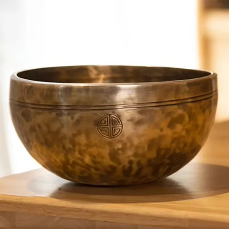 Bronze Tibetan singing bowl with etched shou symbol for meditation and healing