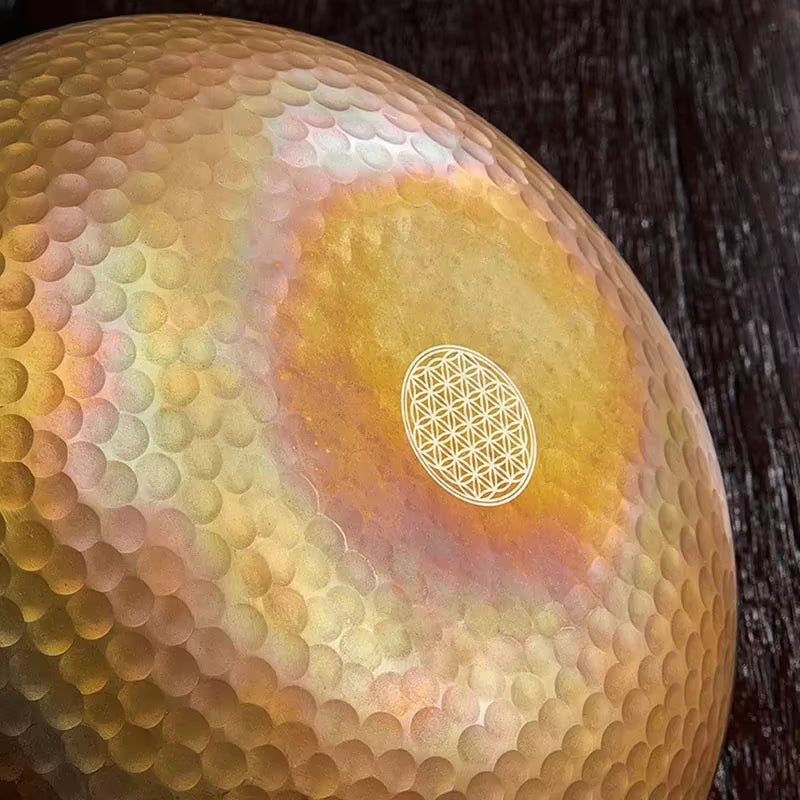 Golden metallic sphere with Flower of Life pattern, ideal for Tibetan Singing Bowl meditation