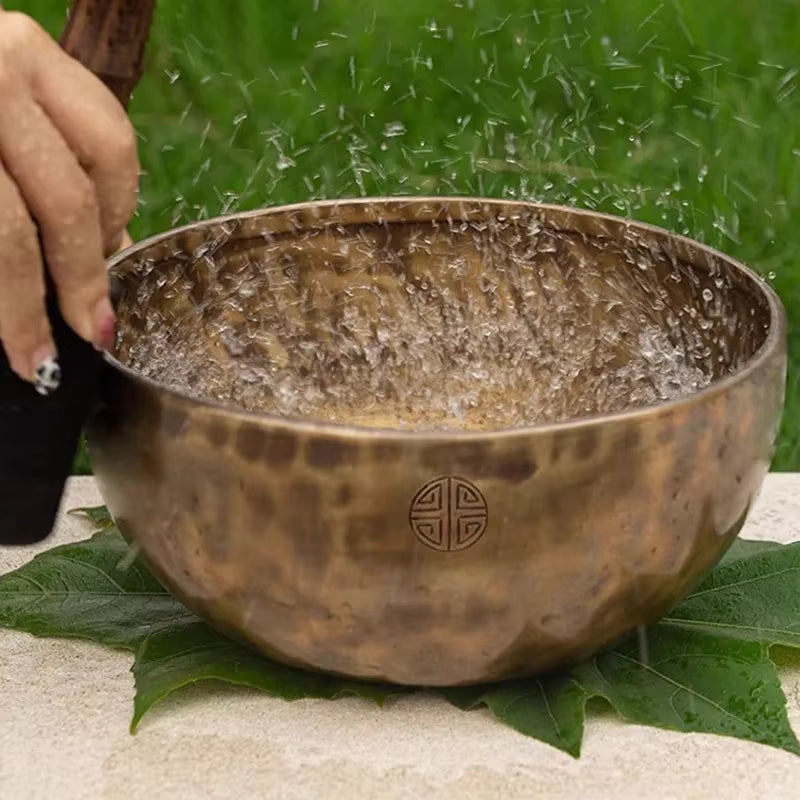 Hammered metal Tibetan Singing Bowl with water droplets for meditation and healing