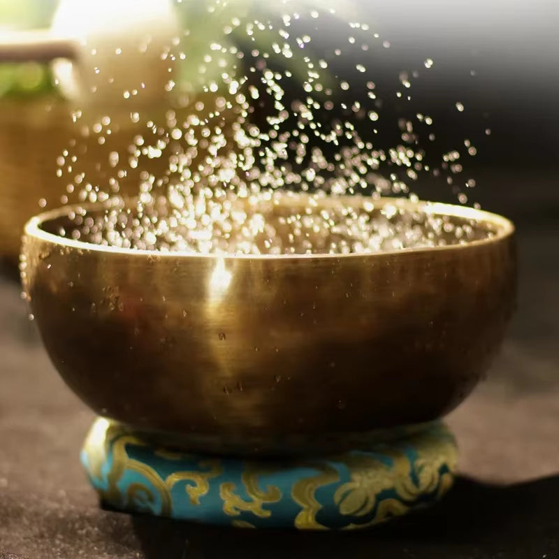 Tibetan Singing Bowl with water droplets splashing for meditation and sound healing