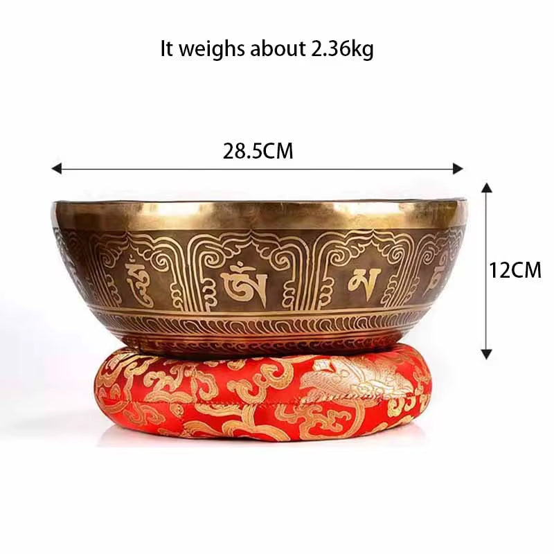 Decorative Tibetan singing bowl on a red cushion with gold patterns for healing