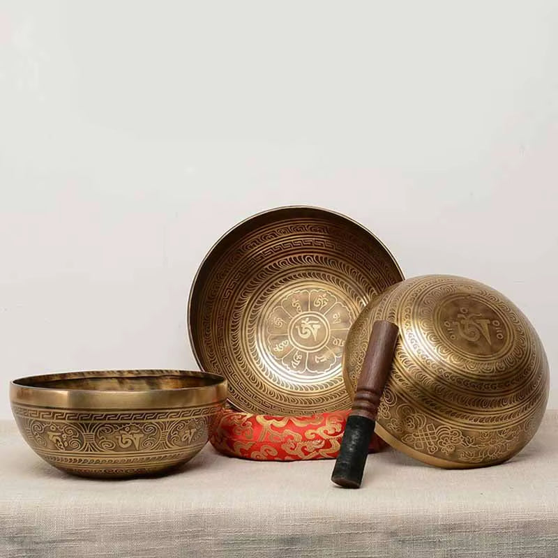 Tibetan Singing Bowl Set for Healing featuring Om symbols and wooden striker