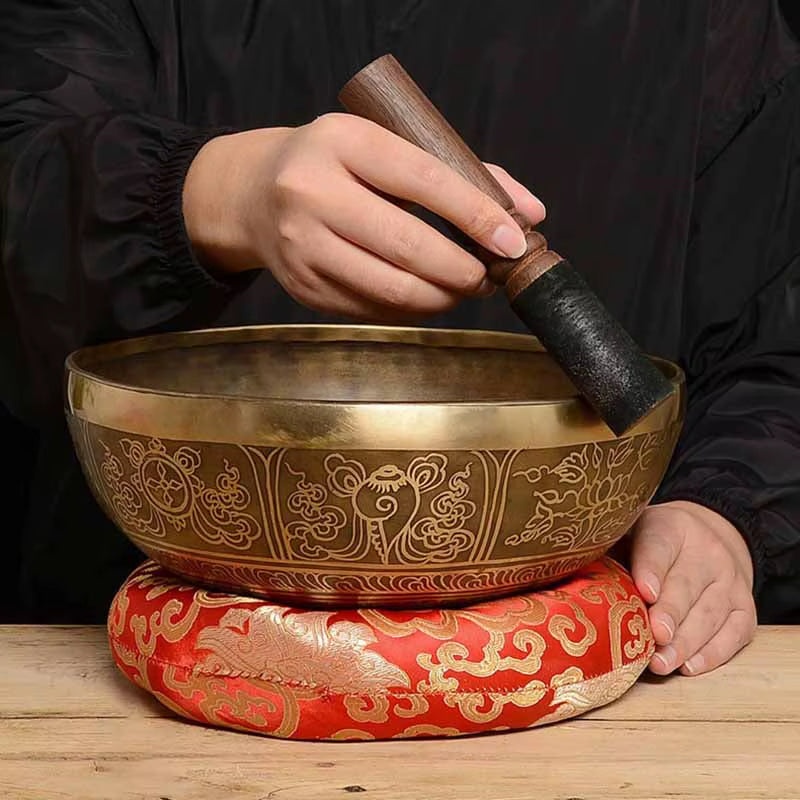 Tibetan Singing Bowl on a red and gold cushion in a Healing Set