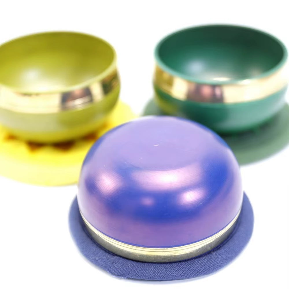 Colorful yo-yos with metallic bands featured in Tibetan Singing Bowl Set for Meditation